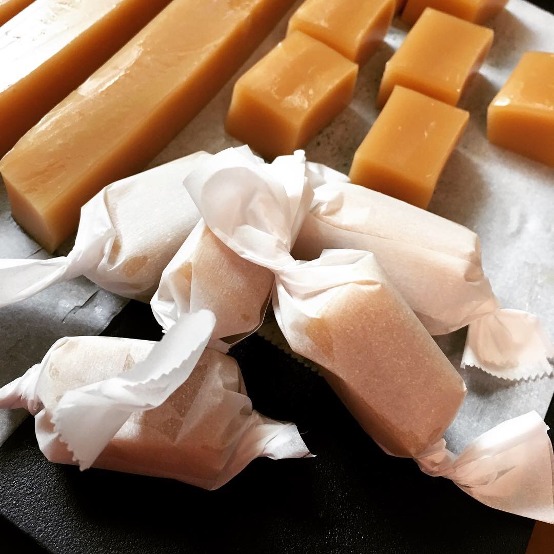 Salted Vanilla Caramel Candies wrapped in parchment paper