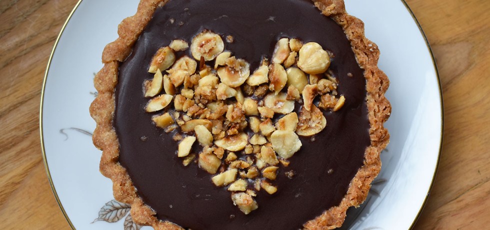Nutella mini tart with candied hazelnuts arranged in the shape of a heart
