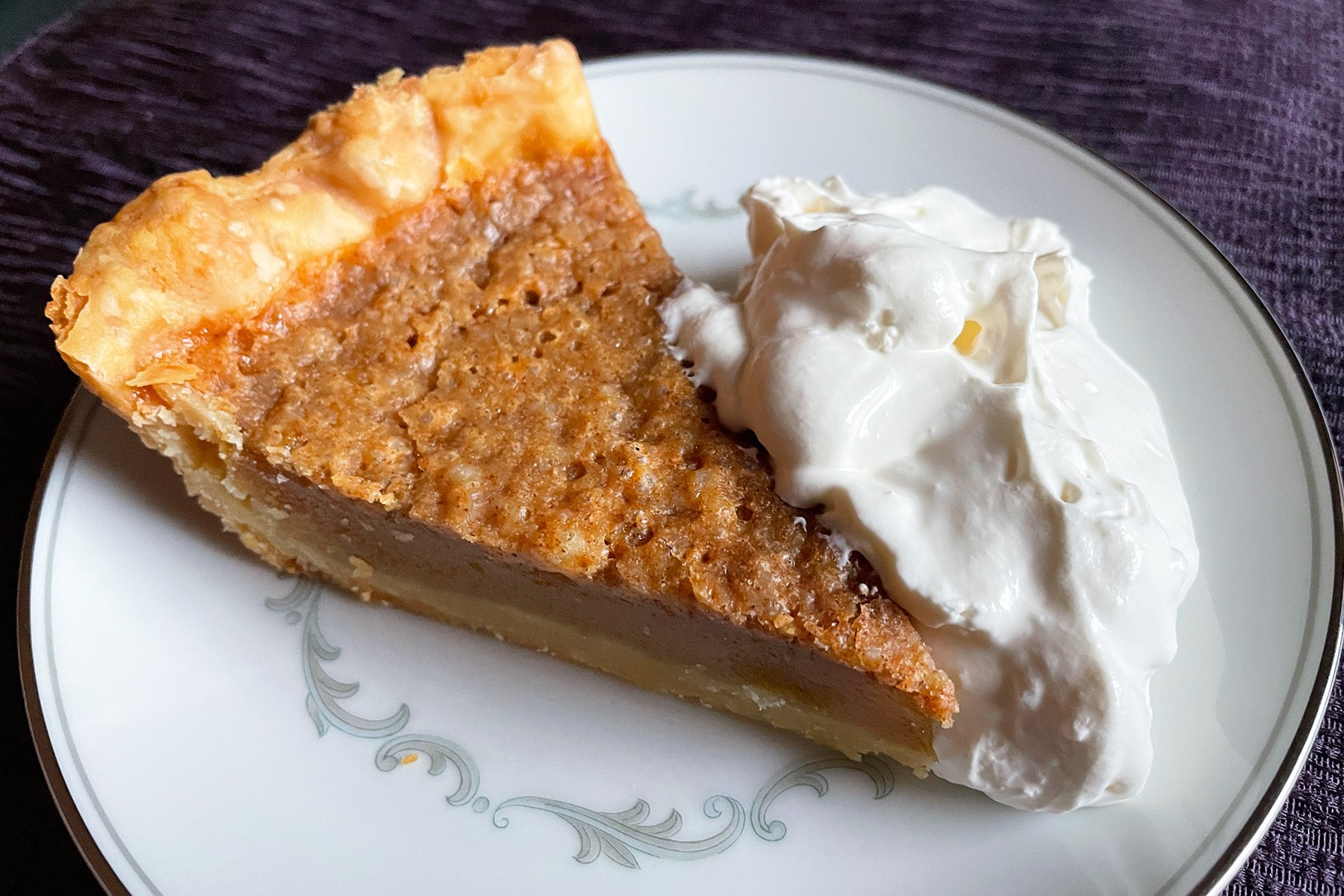 apple cider pie slice with fresh whip cream